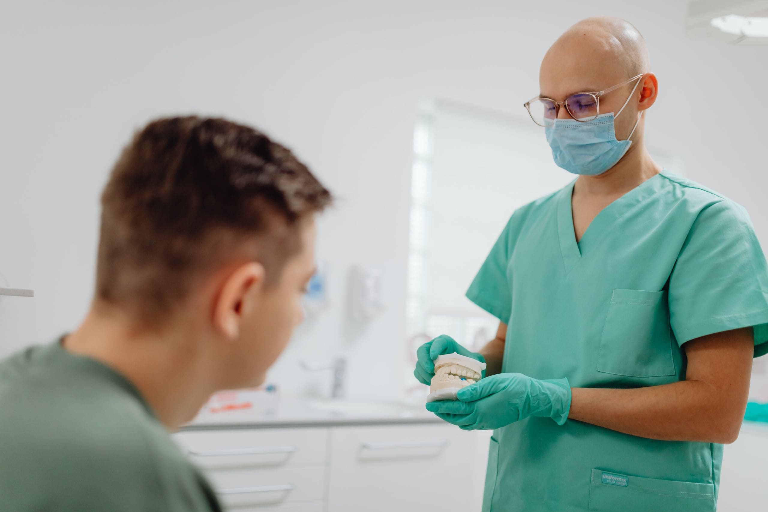 A dentist of any background in a warm, calm conversation with a patient during a consultation