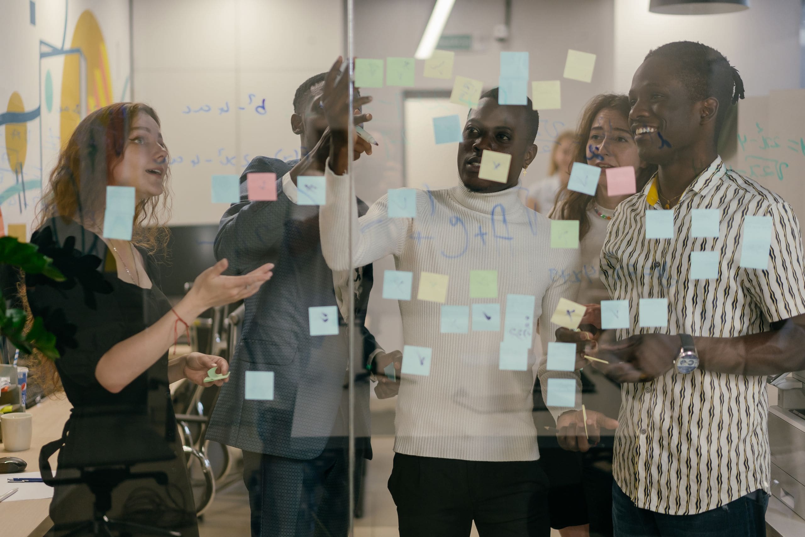 JULY strategists in a planning sprint, sleeves rolled, working through a campaign plan together